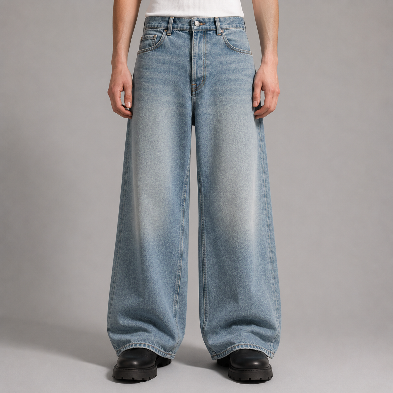 Person wearing light blue wide-leg jeans on a gray background