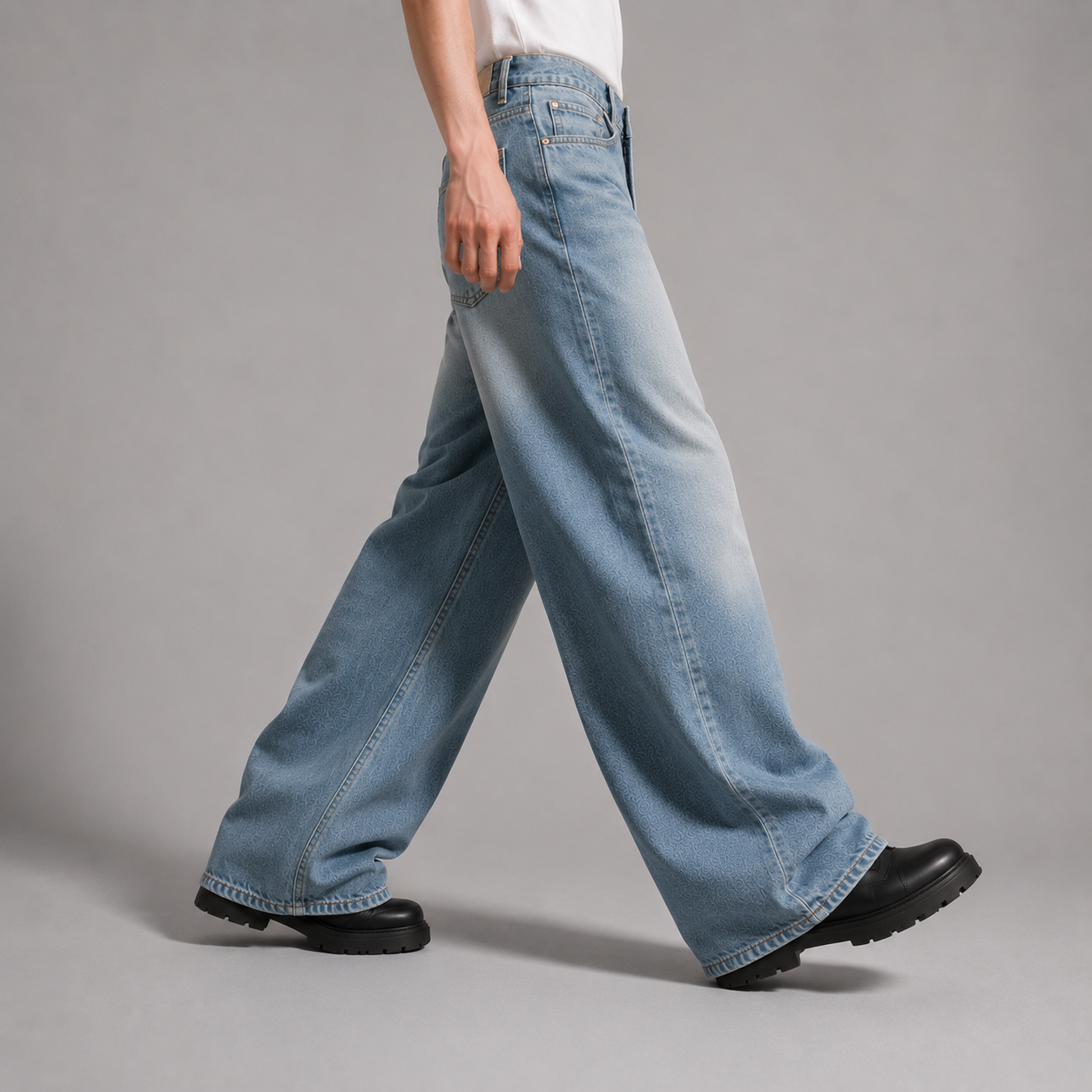 Person wearing light blue jeans on a gray background
