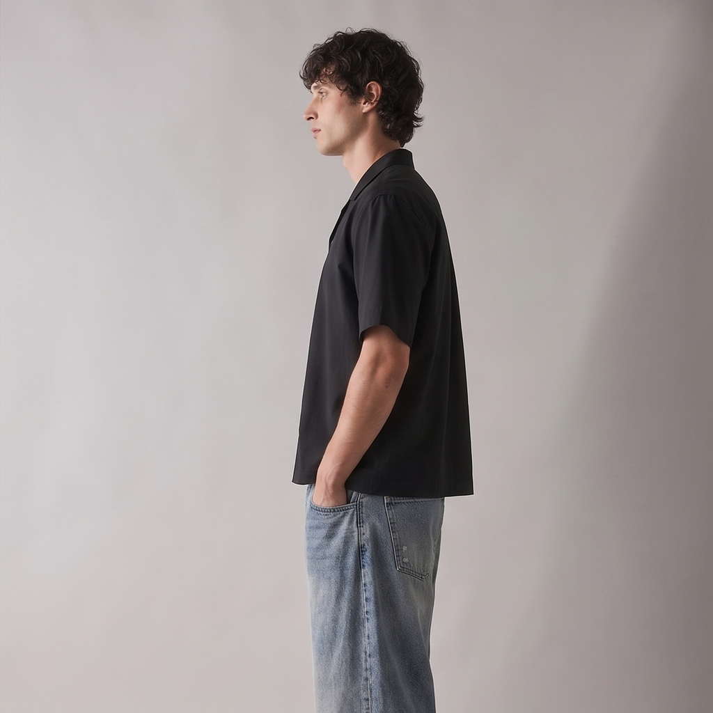 Person wearing a black shirt and blue jeans against a plain background
Side view of ARC Black Boxy Fit Shirt highlighting the oversized boxy silhouette, sleeve structure, and relaxed fit.