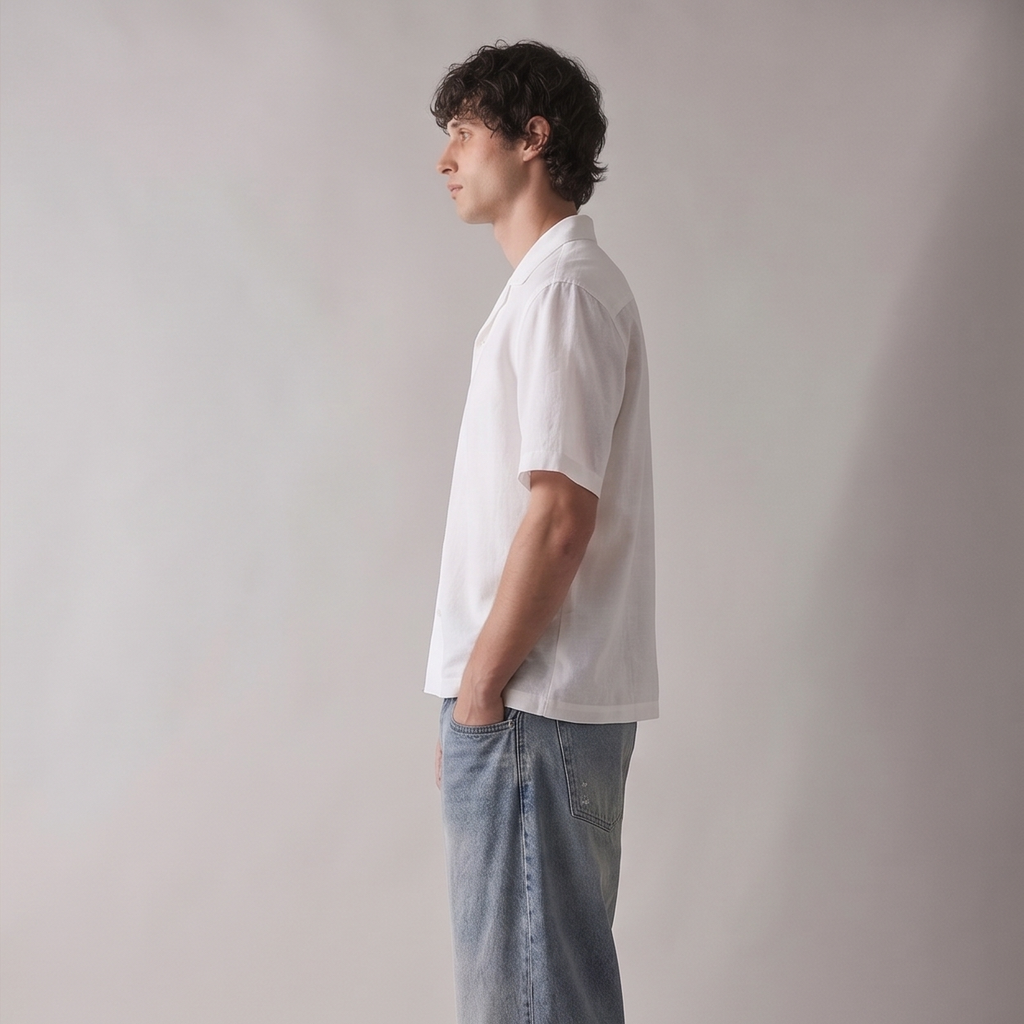 Man wearing a white shirt and light blue jeans against a plain background
Side view of ARC White Boxy Fit Shirt highlighting the relaxed boxy fit, sleeve structure, and contemporary silhouette.